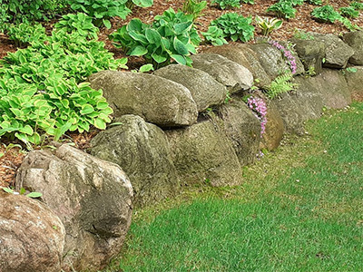 Boulder retaining wall installation, design, removal, and installation services from ZNT Property Services.